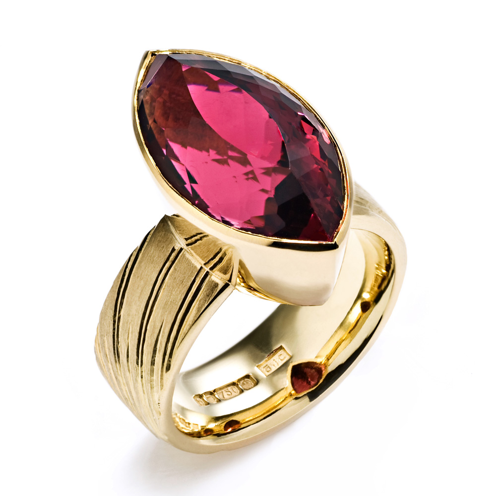 18ct gold, engraved with rising sun motive, set with marquise rubelite tourmaline. 2008. Photo: Simon B Armitt