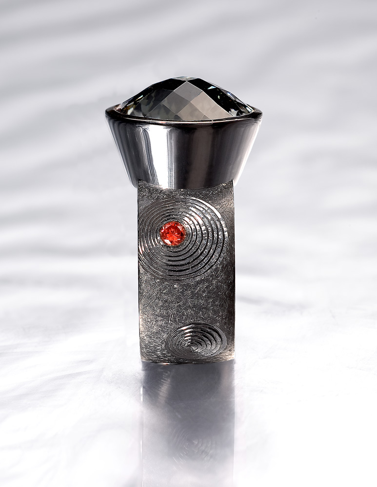 Silver, hand engraved, black rhodium plate, oval chequerboard cut grey/green tourmaline, pink diamonds. 2008/9.Photo: Simon B Armitt