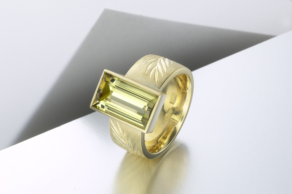 18ct yellow gold, hand engraved cut with interlocking olive branches, olive green tourmaline baguette. Photo: Paul Hartley