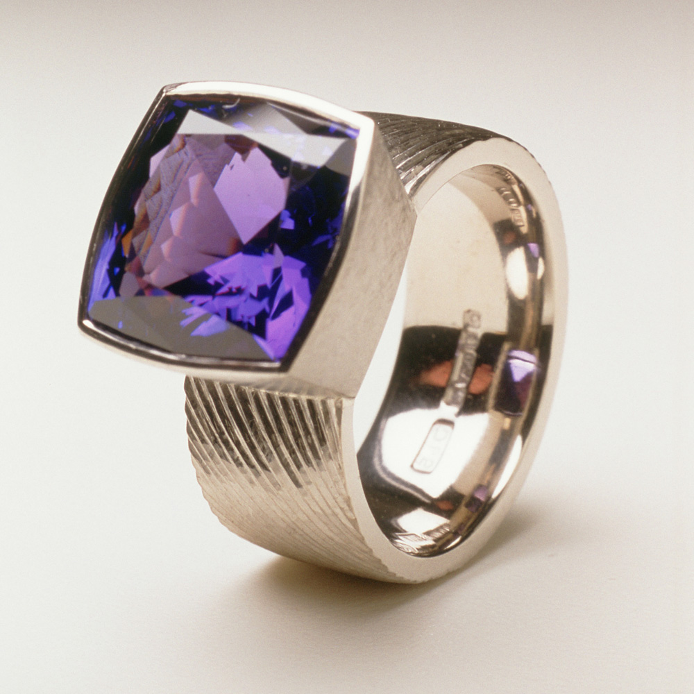 18ct white gold, hand engraved, cushion cut tanzanite, 7.18cts.