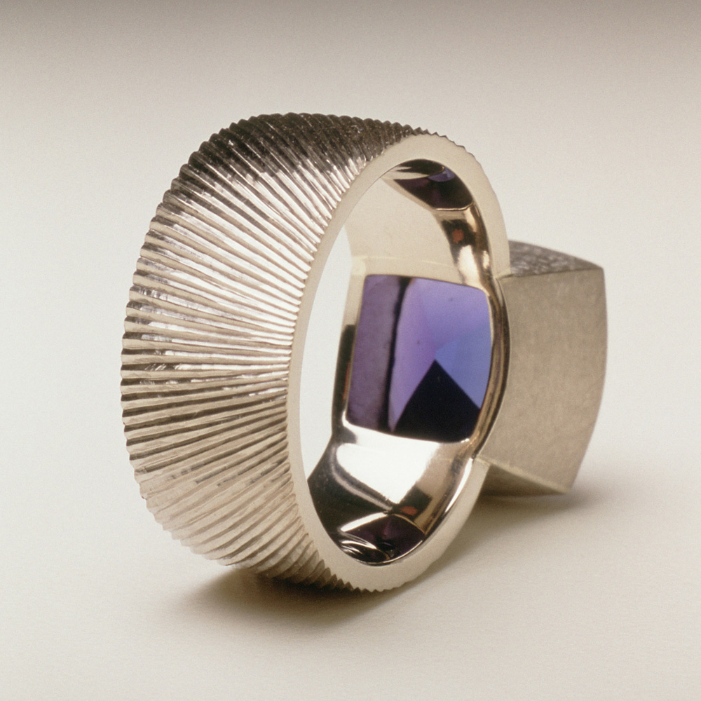 18ct white gold, hand engraved, cushion cut tanzanite, 7.18cts.