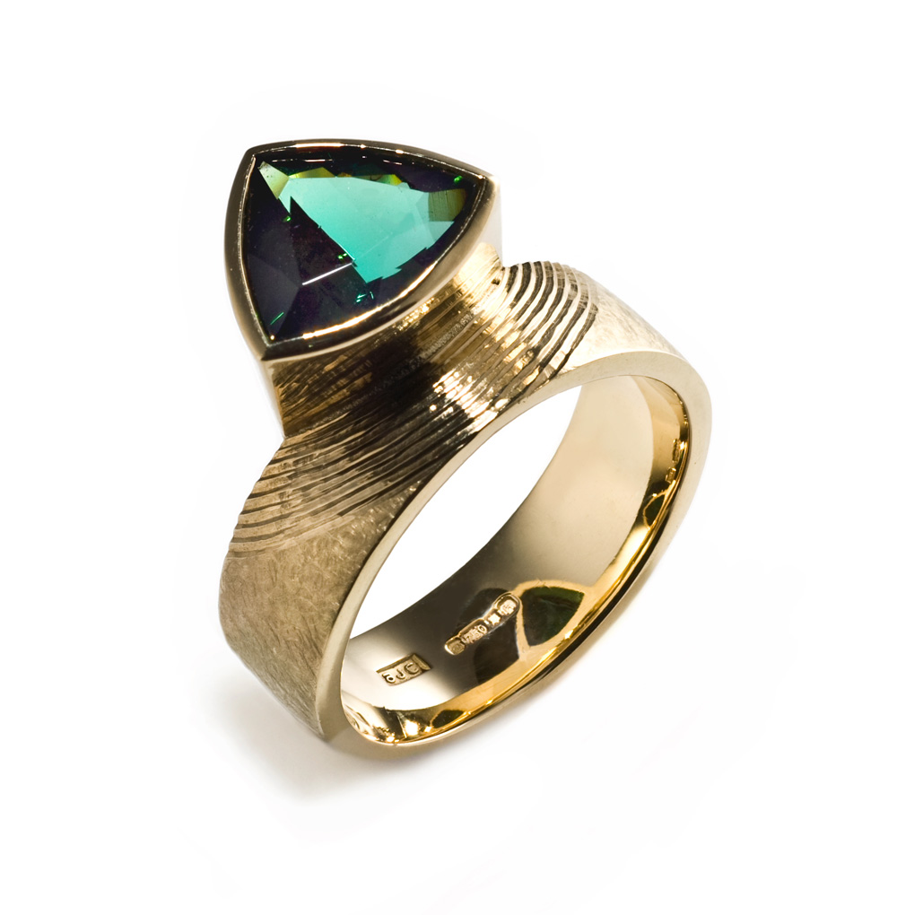 18ct gold, hand engraved, trillion cut deep green tourmaline. Photo: Simon Armitt