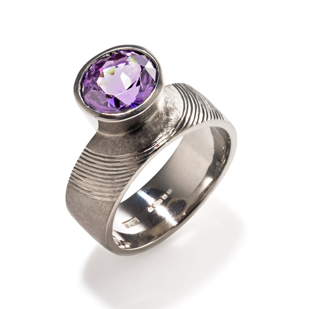 18ct white gold, hand engraved, set with oval cut mauve spinel. Photo: Simon B Armitt
