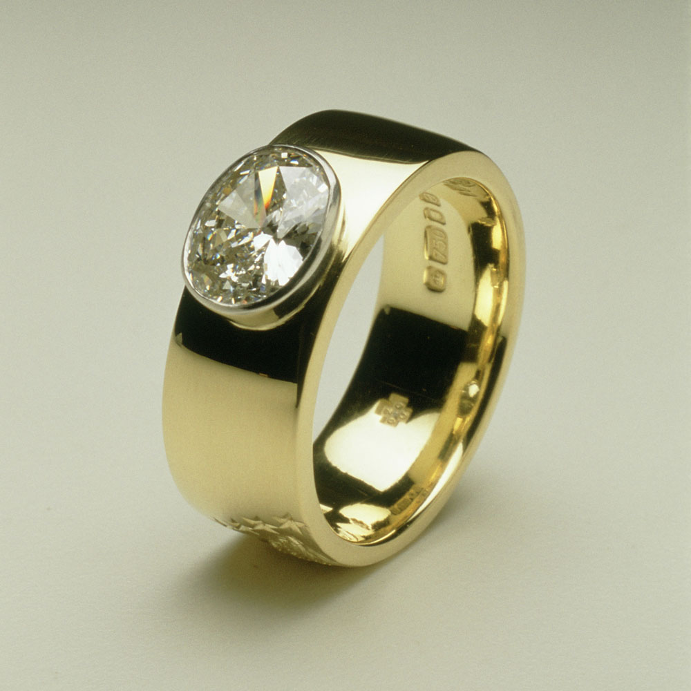 18ct gold, set with oval diamond 1.02cts. Shank is hand carved with an owl which is a significant animal for the client. 
