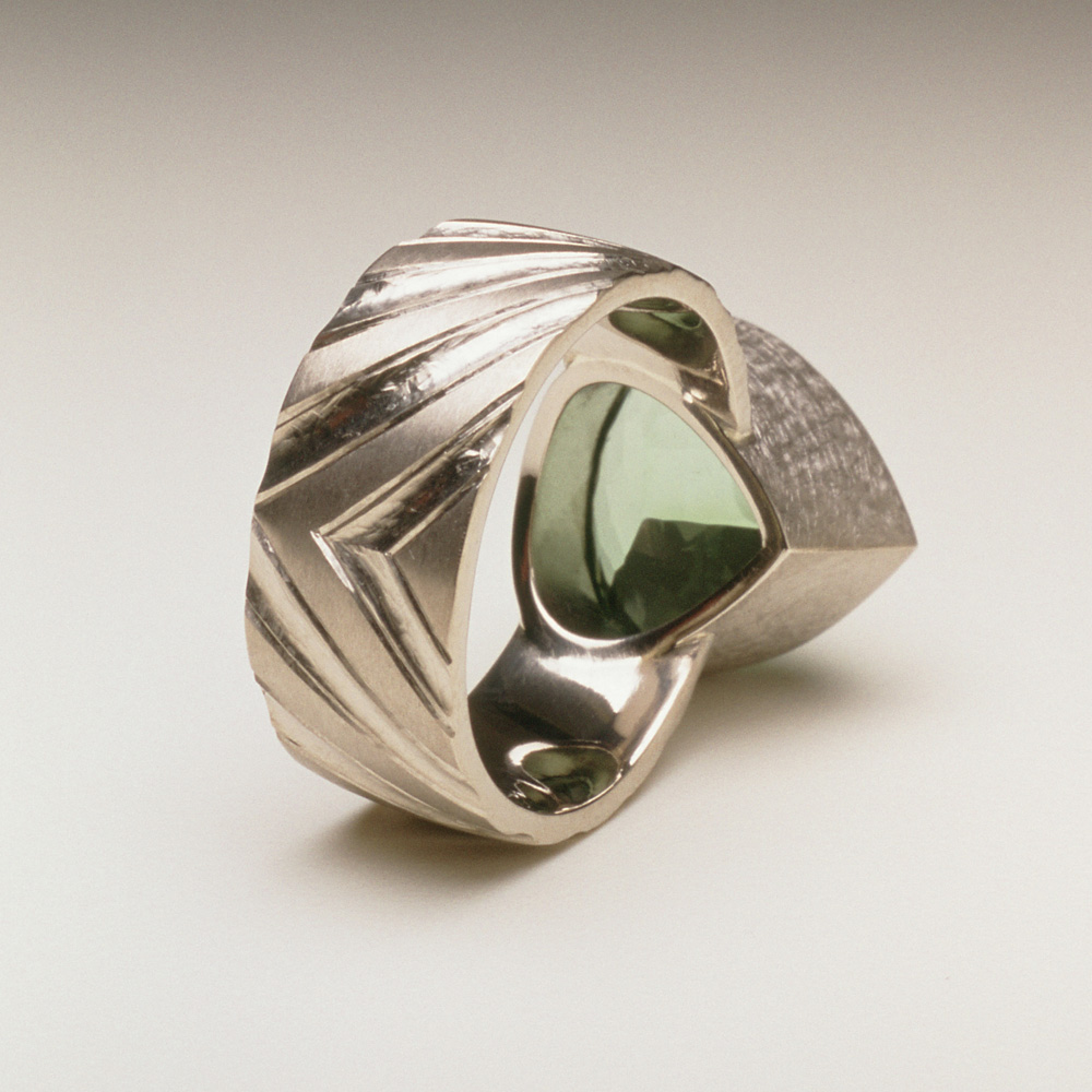 18ct white gold, hand carved and engraved, pale green tourmaline.
