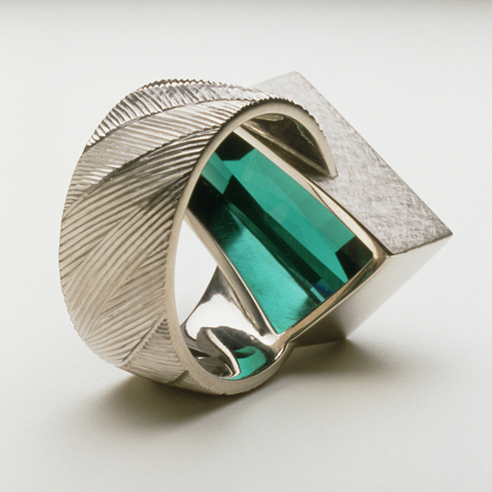 <a href="/jewellery/reverse-detail-6">Reverse detail: Dress ring, 18ct white gold, hand engraved, rare blue tourmaline. Commission piece. Photo: Joel Degen</a>