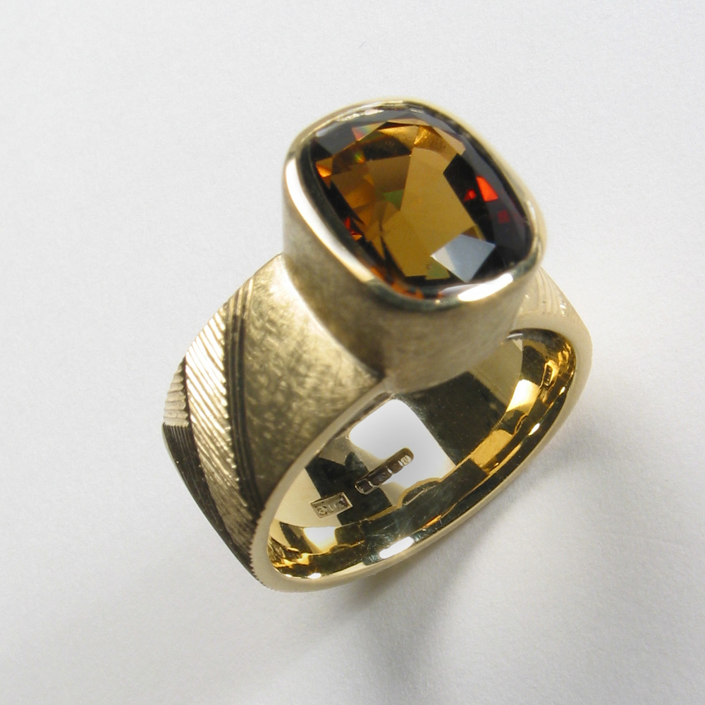 18ct yellow gold, hand engraved, brown/green cushion-cut tourmaline.