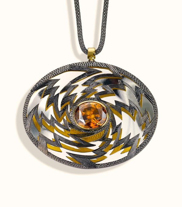 <a href="/node/261">PENDENT “Golden Lightening” Oval 6cm x 4 cm. Silver hand engraved, hand pierced, mirror behind to reflect the underside.  Stone oval Zircon in orange / brown. set in 18ct gold.  View 2 Face on light reflections, White background</a>