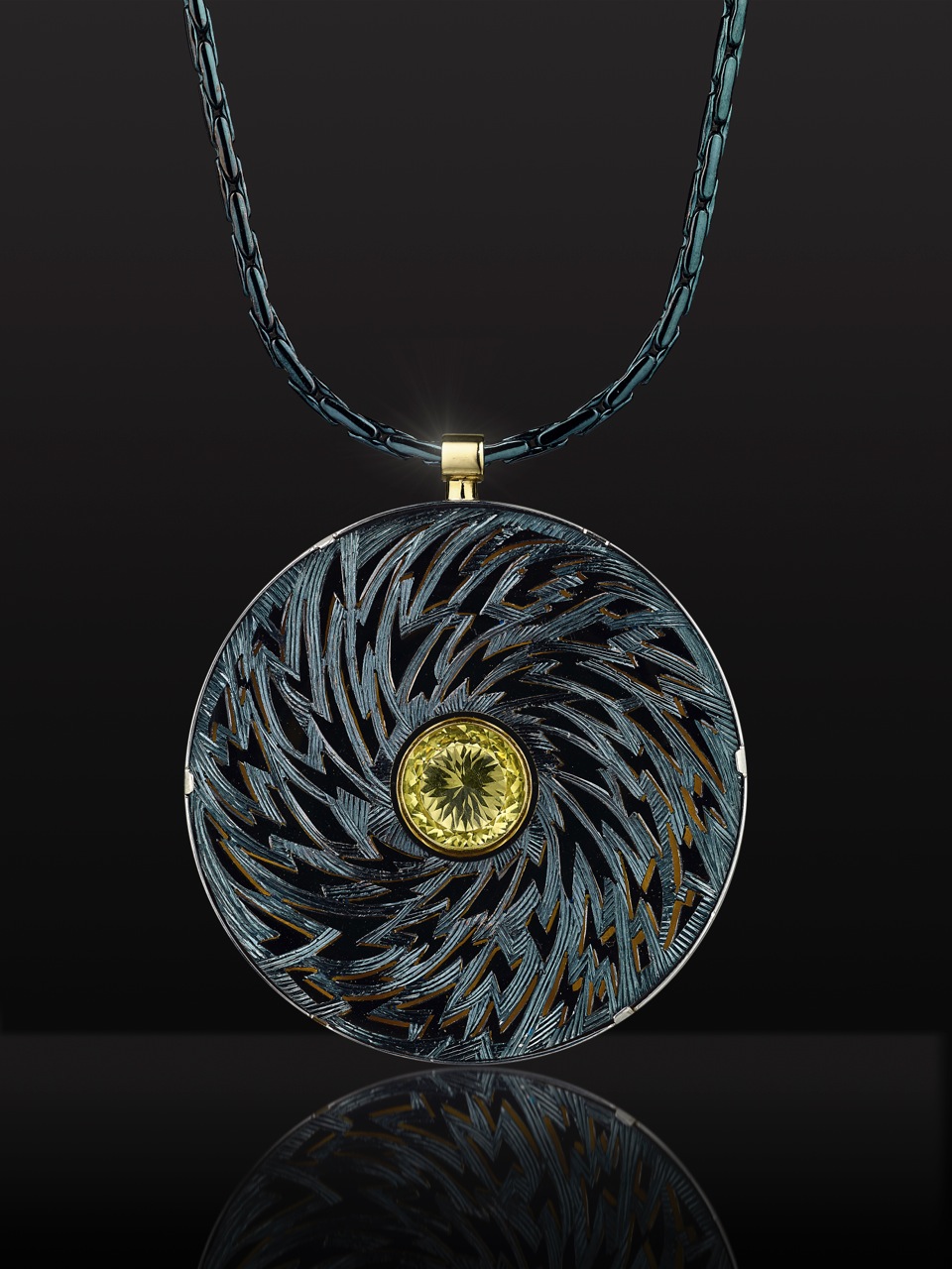 Silver, pierced and hand engraved. Finished in blue/black rhodium, lemon quartz. 6cm diameter.