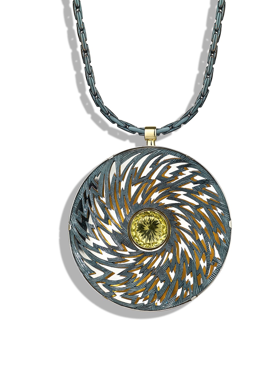 Silver, pierced and hand engraved. Finished in blue/black rhodium, lemon quartz. 6cm diameter.