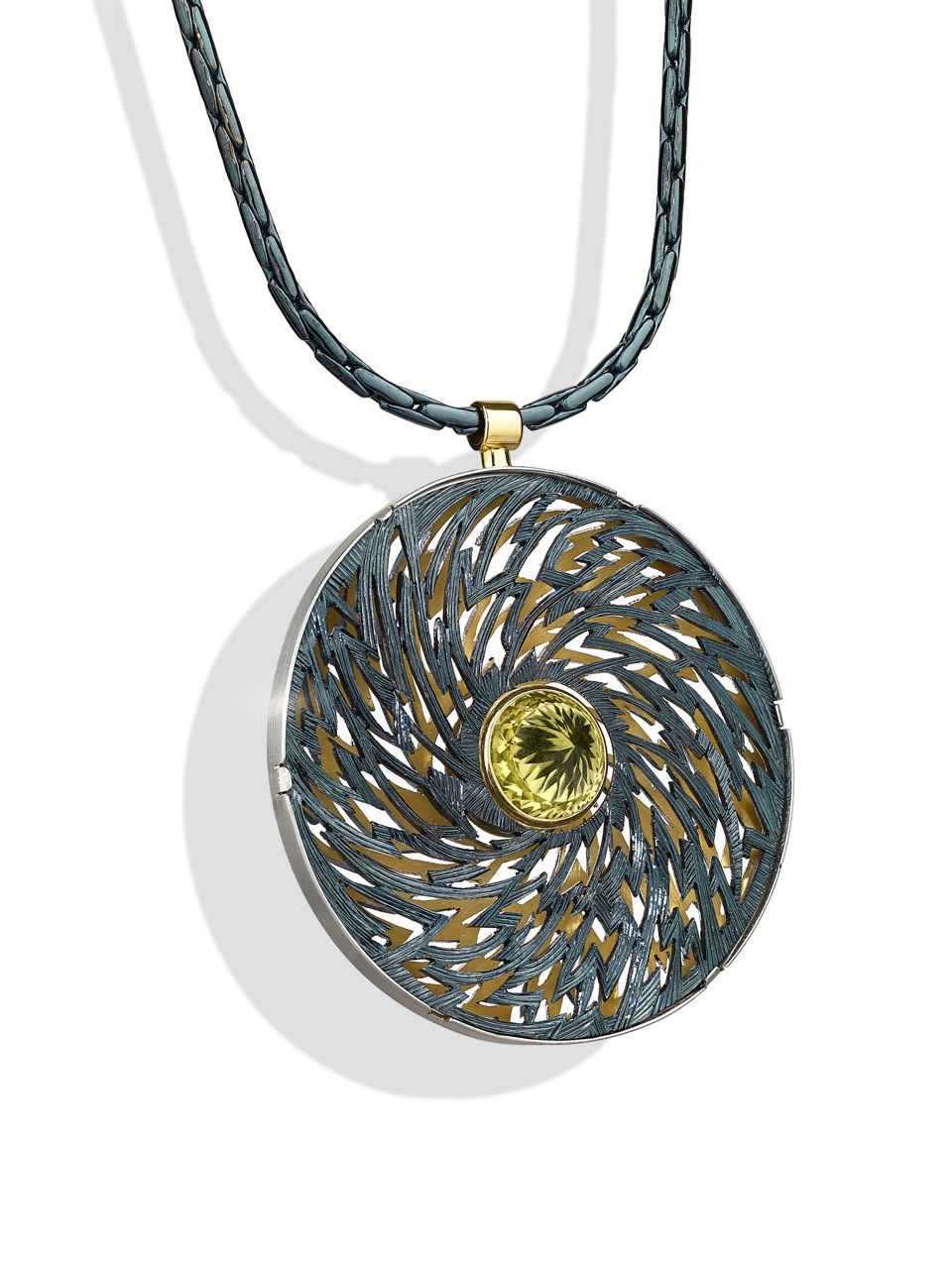 Silver, pierced and hand engraved. Finished in blue/black rhodium, lemon quartz. 6cm diameter.