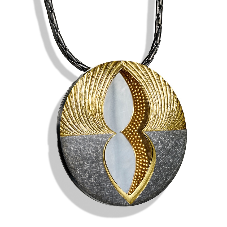 Part hand engraved and carved with gilded finish. Underside also gilded to reflect in mirror finished back, part scrubbed finish, dark grey rhodium plated. 6.2 cm diameter.