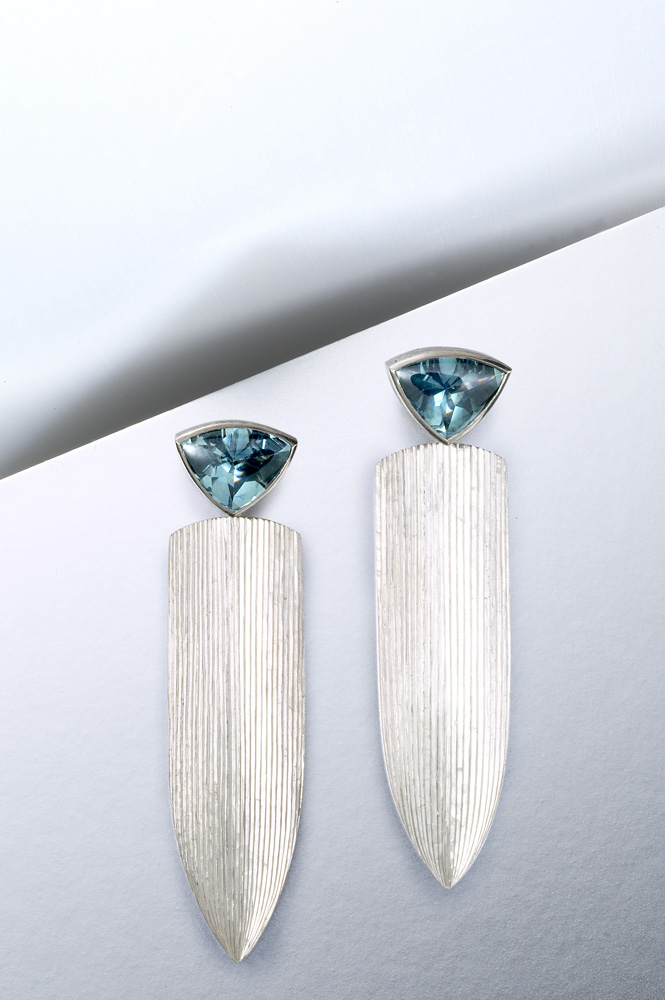 18ct white gold, hand engraved, set with trillion 'buff top' Montana sapphires. 40mm. Photo: Paul Hartley