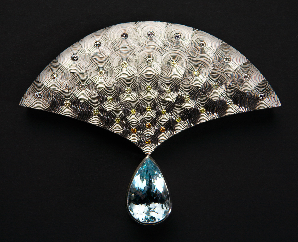 18ct white gold, hand engraved, set with white and coloured diamonds, fading from white to orange. Aquamarine drop 9.74cts.
