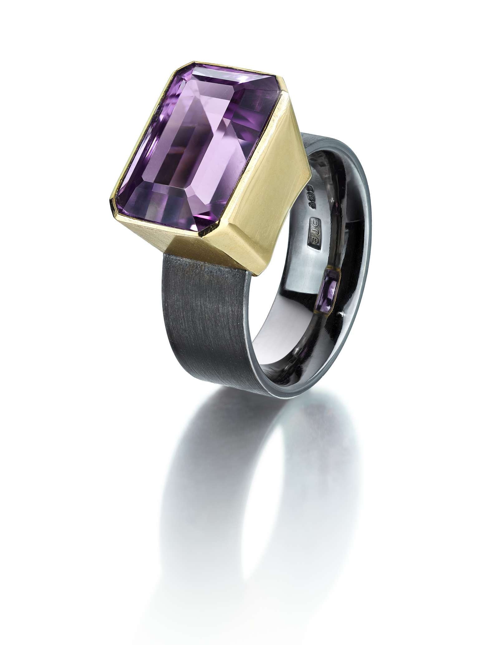 <a href="/node/291">Amethyst Dress Ring size Q. Fine Pale Amethyst set in 18ct gold / Ring shank brushed on the outside and polished inside finished in black rhodium. Photo : Simon B Armitt</a>