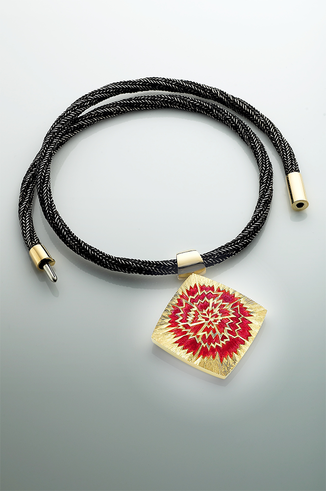 18ct yellow gold drop with champleve carnation in pink enamel and engraved surface. Oxidised hand knitted silver chain, 18ct yellow gold clasp.Photo: Paul Hartley