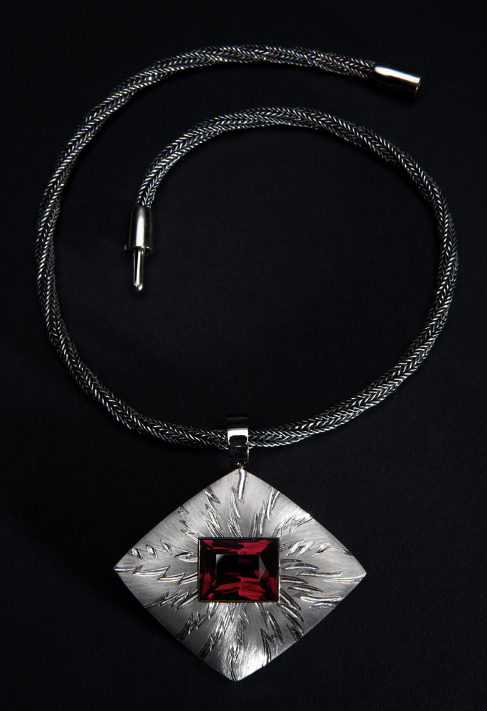 18ct white gold, hand engraved, carved and striated, rectangular garnet 18.77cts. 6cm x 6cm.Photo: Simon Armitt