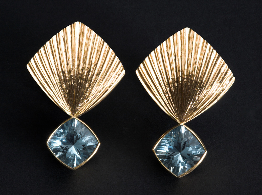 18ct yellow gold, hand engraved. Set with pair of laser cut aquamarines. Clip and post fittings. Size of earring tops: 20mm square. Photo: Simon Armitt