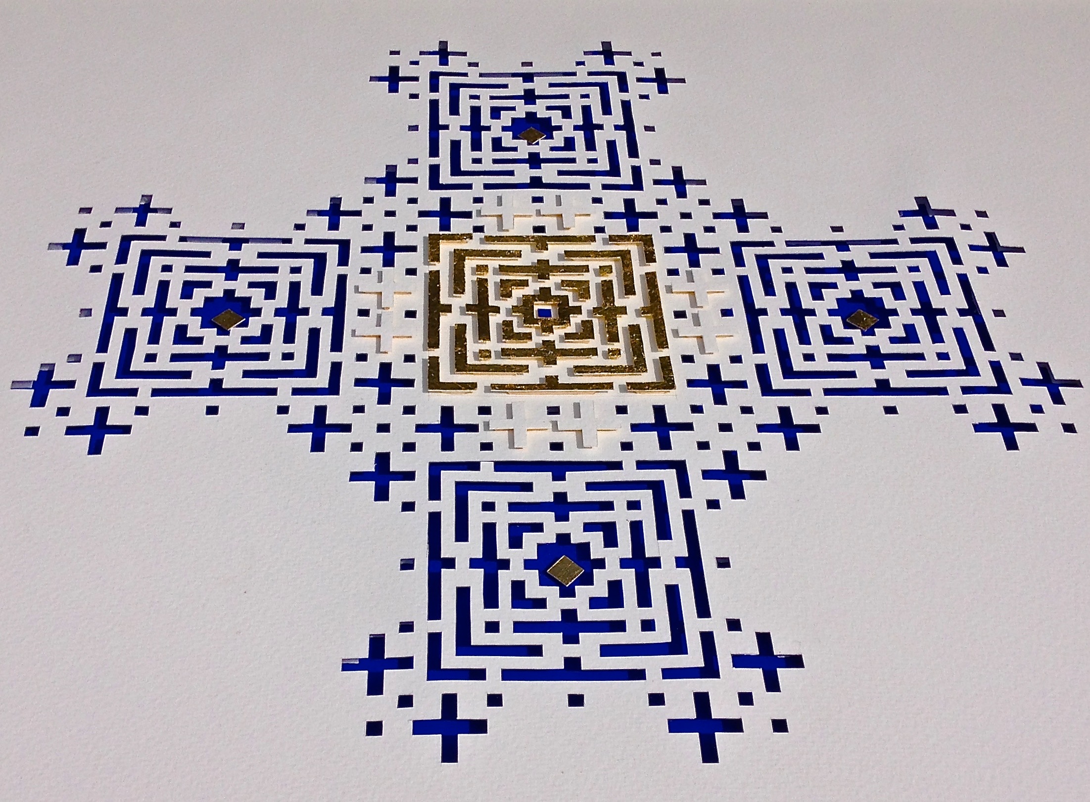 White handmade paper, cobalt blue mount board, gold leaf. 63cm x 83cm.This large piece is part laser cut, part hand cut. In daylight the cuts and raised parts throw shadows; in candlelight it is more ancient and mysterious.