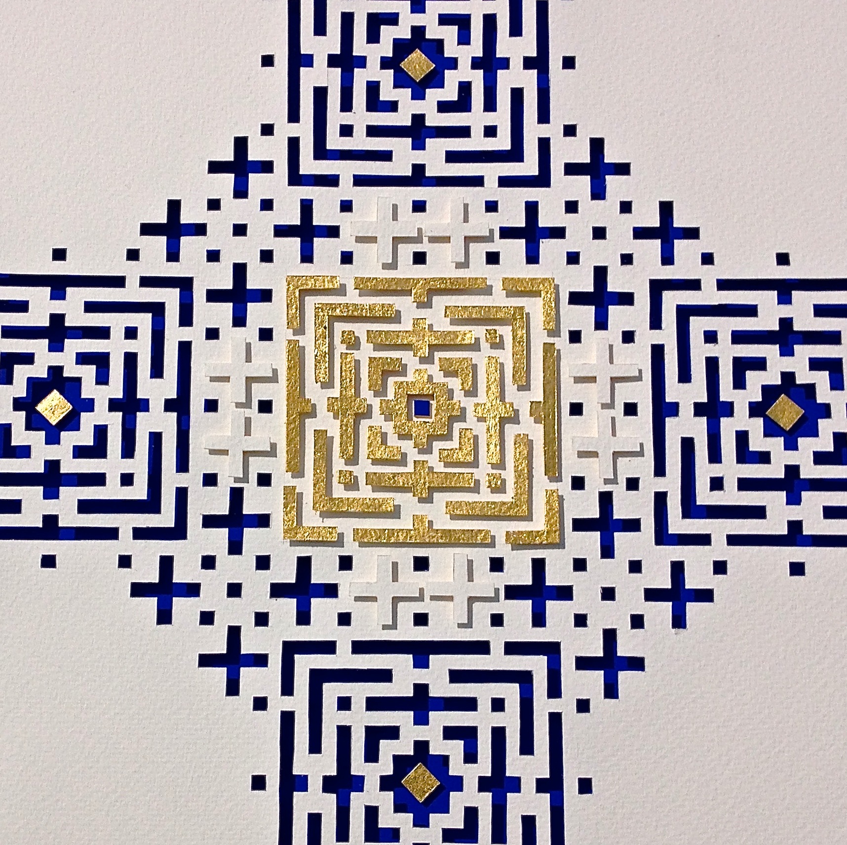 Taken on my iPhone / Paper Cut 63cm x 83cm /Untitled / white handmade paper, Cobalt Blue mount board, Gold leaf. This largepiece is part laser cut / part hand cut. In daylight the cuts and raised parts throwshadows, in candlelight it is more ancient and mysterious.