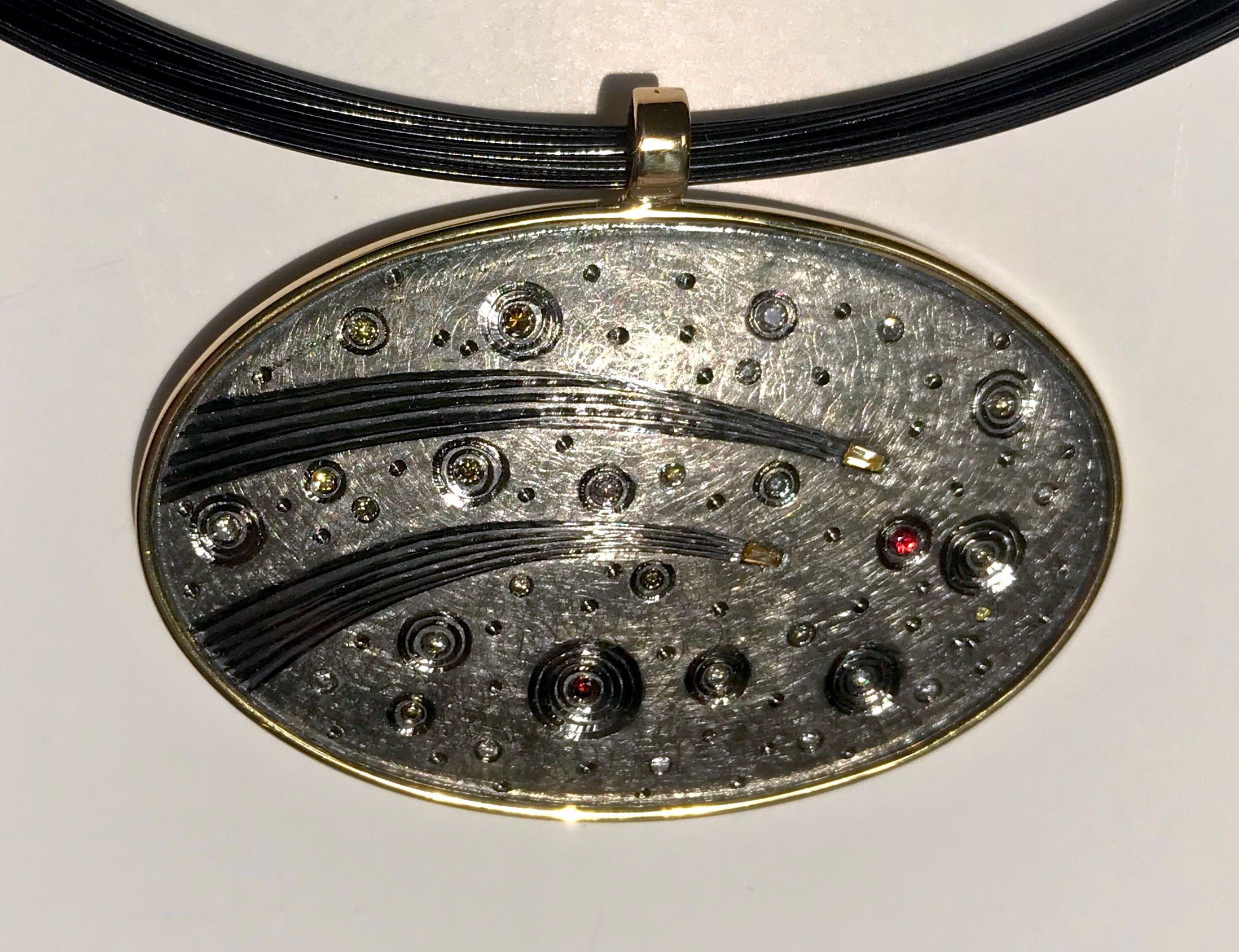 50th wedding anniversary commission.18ct gold, silver, hand engraved, set with various coloured diamonds, finished in black rhodium plate. 