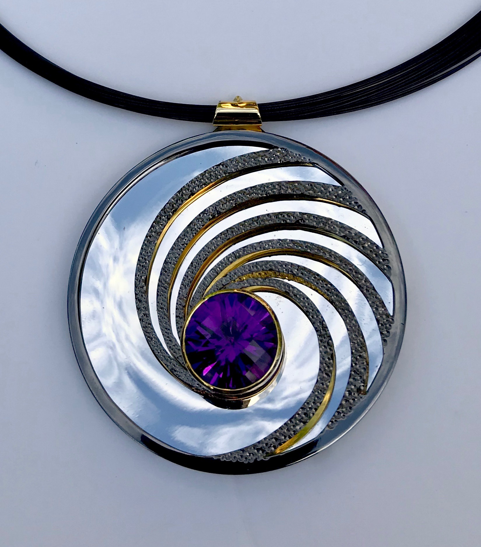<a href="/node/295">Swinging on a Star. Dark Amethyst / Silver / Part Gilded part Rhodium Plate / the mirror on the inside back will reflect whatever its facing - here it’s the Sky.</a>