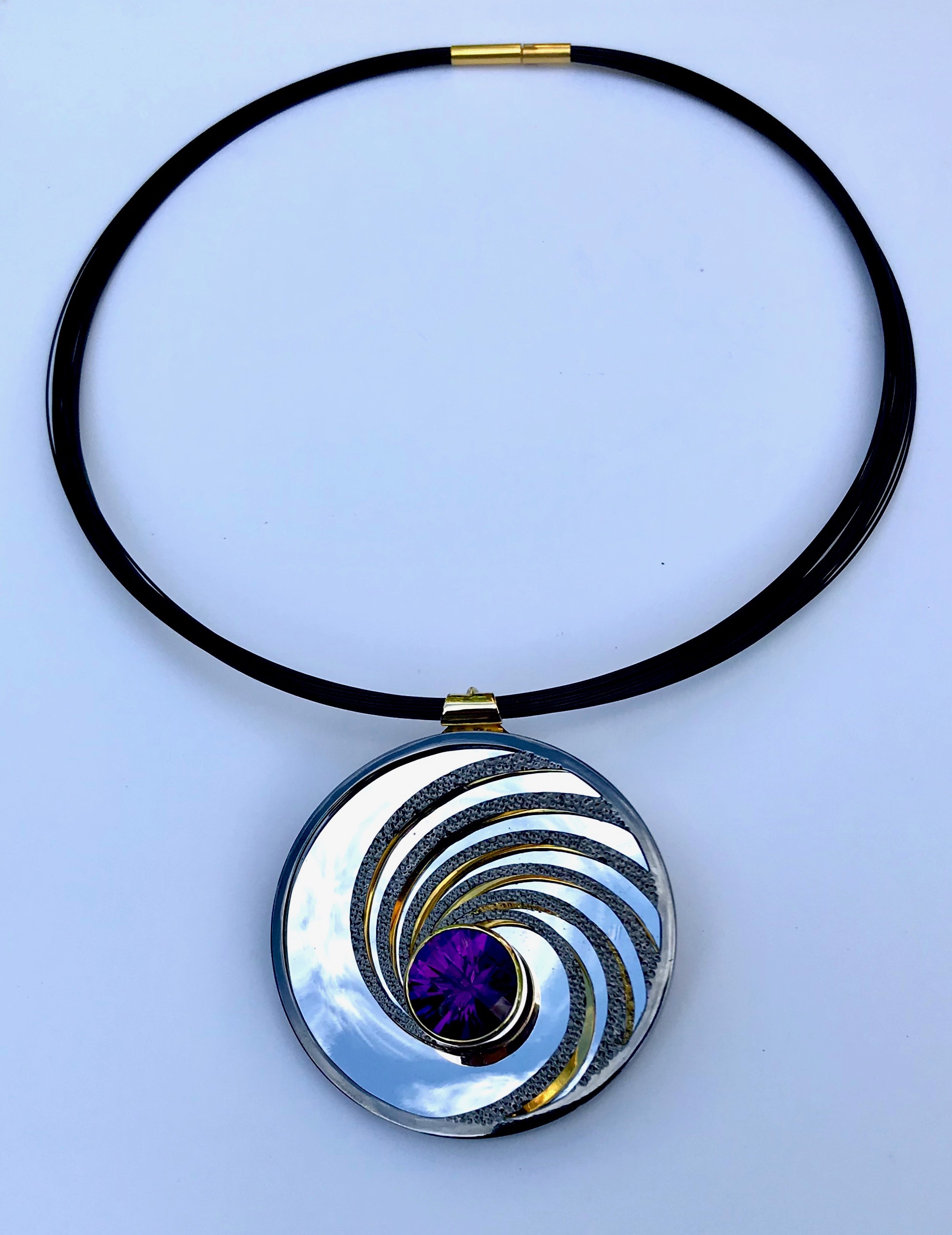 Dark Amethyst, silver, part gilded, part rhodium plated. The mirror on the inside back will reflect whatever its facing - here it’s the sky.