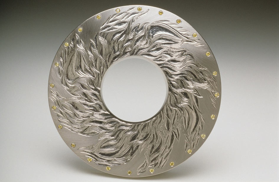 18ct white gold, hand engraved and carved, 6cm diameter, set with 24 yellow diamonds. Photo: Joel Degen