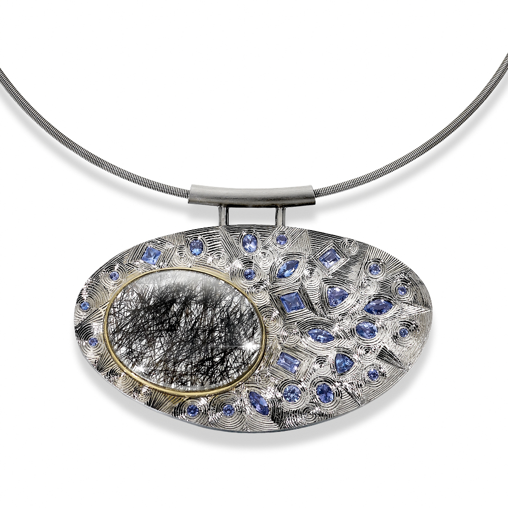 Silver finished in grey rhodium, hand engraved, set with various shaped tanzanites and one oval rutilated quartz set in yellow gold. Stainless steel chain. Photo: Simon B Armitt.