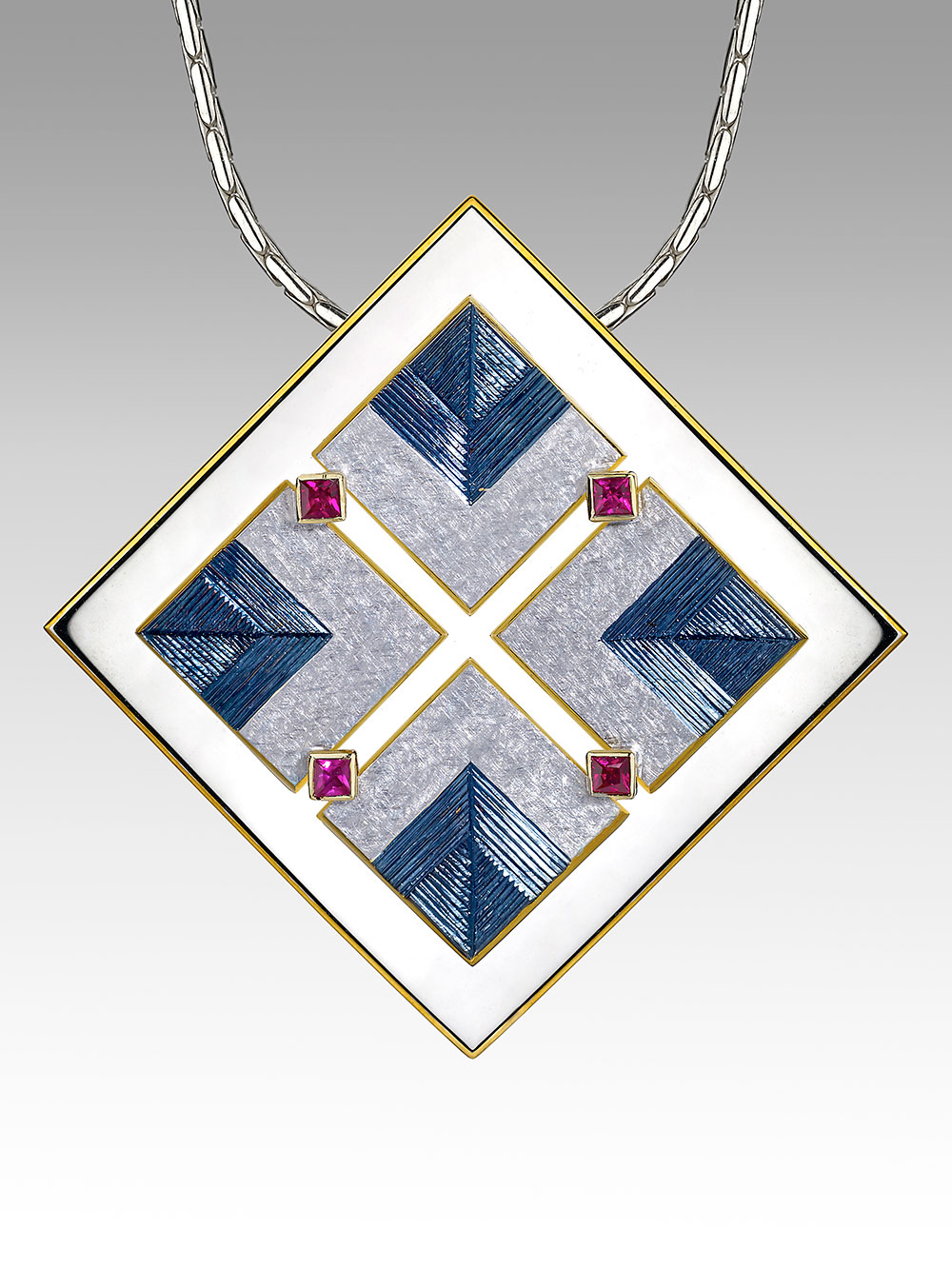 Silver and 18ct gold, gilding and rhodium plate in various colours, hand engraved, set with four square red spinels. Victoria & Albert Museum permanent collection.Photo: Simon B Armitt 