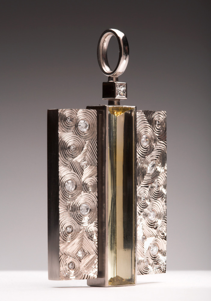 18ct white gold, set with client's diamonds, centre stone: pale yellow beryl baguette. 5cm high x 2.8cm wide. Photo: Simon B Armitt.