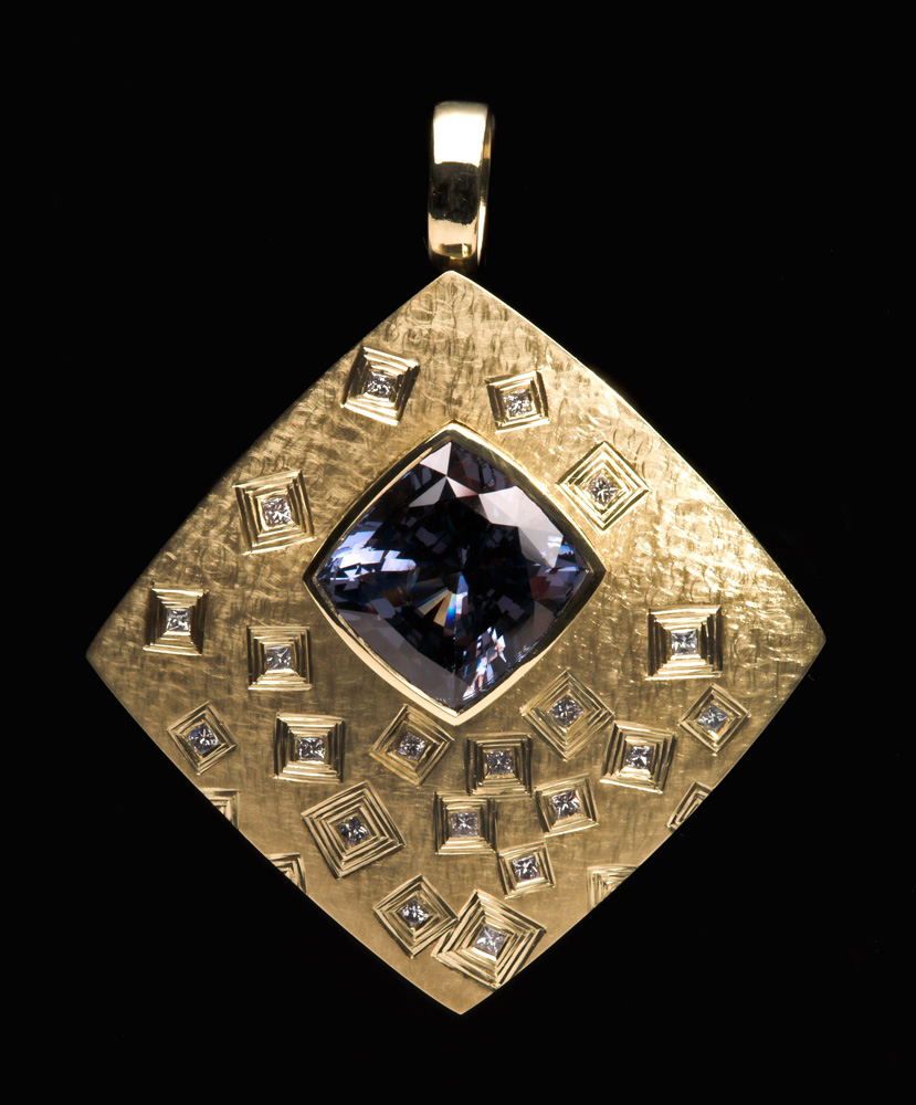 18ct green gold, hand-engraved, set with princess cut diamonds, main stone cushion cut charcoal/violet spinel. 4cm wide x 4.8cm high. Photo: Simon B Armitt.