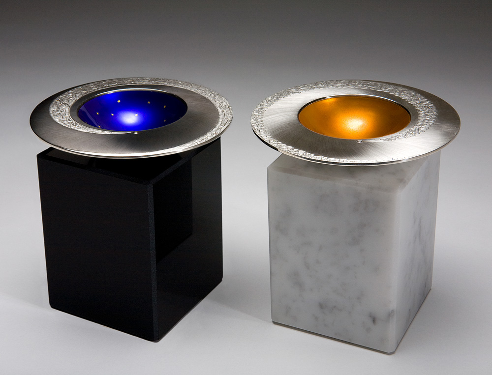 SPINNING COMET BOWLS - DAY & NIGHT. 2009, Silver, hand engraved, enamel and gold leaf. Bases in black obsidian and white marble. Bowls 110 mm diam, bases 7.5 x 7.5 x 10 cm. Photo : Simon B Armitt.