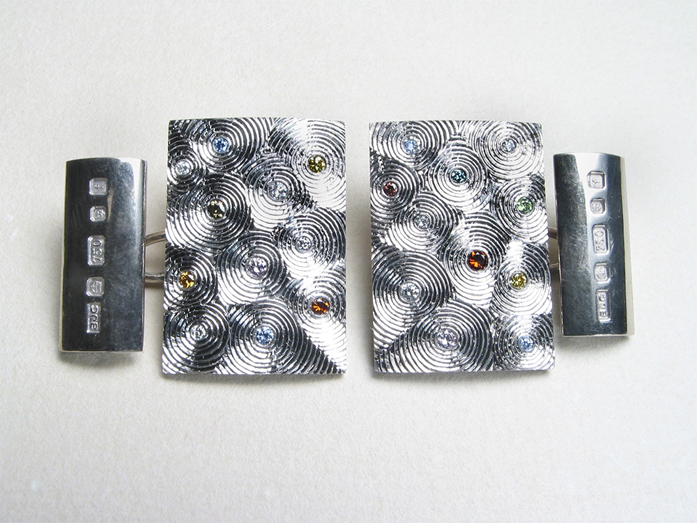 18ct white gold, hand engraved, white and coloured diamonds. Photo: Andra Nelki.