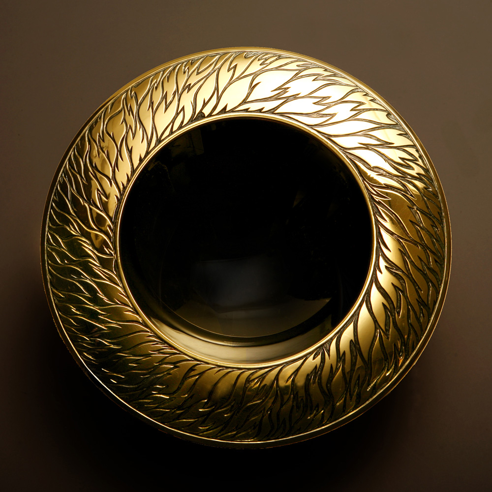 "Dazzling Darkness" Spinning Bowl. 150 mm diam. Brittania Silver, black and yellow gilding, hand engraved and carved. Stone Base - Limestone. Photo : Andra Nelki