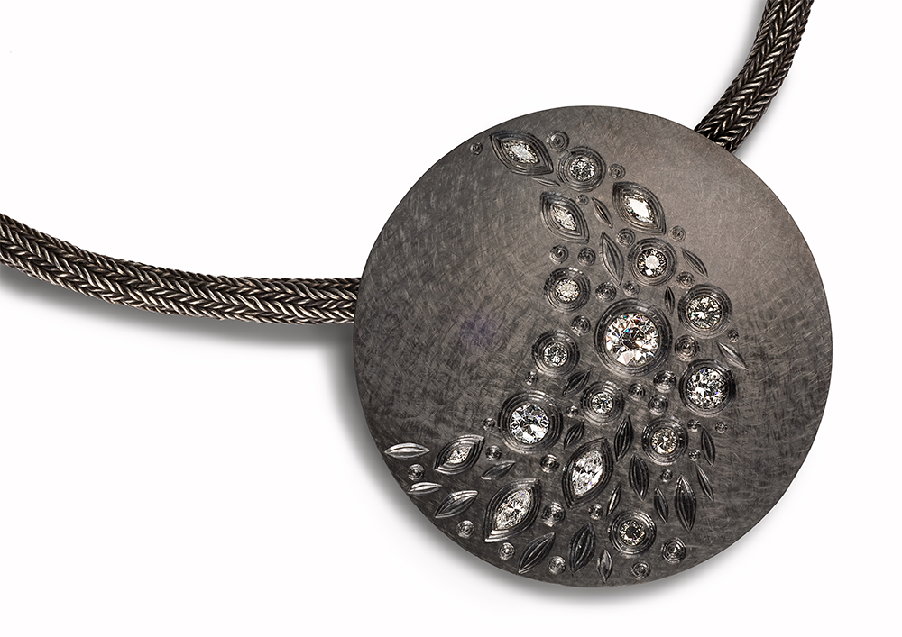 Silver, hand engraved, finished in black rhodium, set with various white grey, brilliant, marquise and old cut diamonds. 9.6 mm diameter. 2008/09. Photo: Simon B Armitt.
