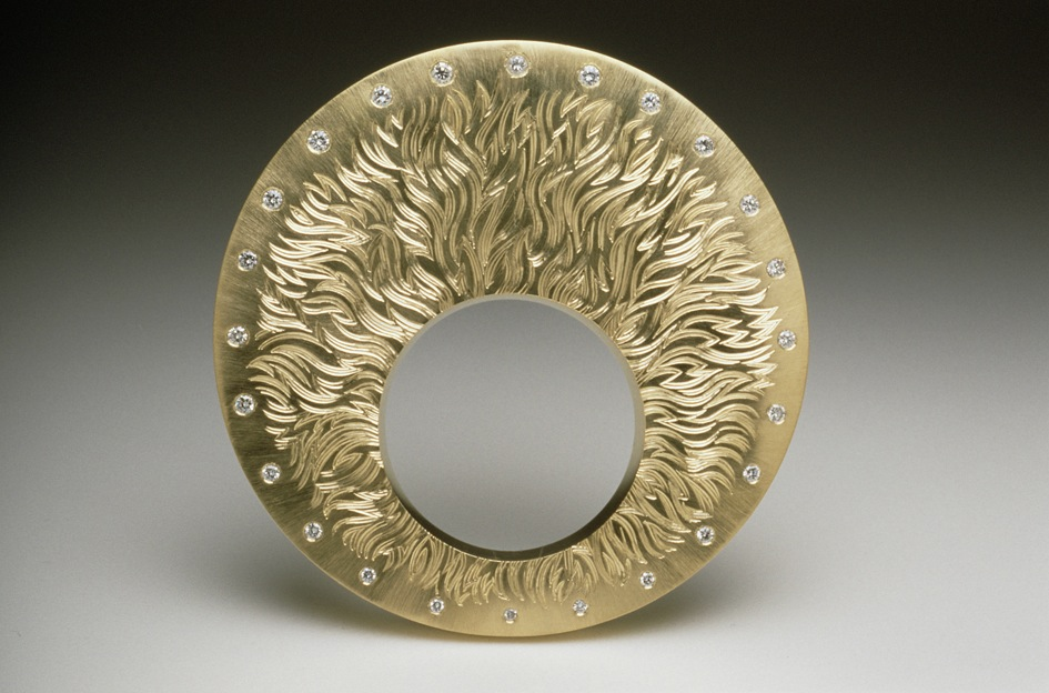 18ct yellow gold, hand engraved, set with 24 white graduated diamonds. 6cm diameter. Photo: Joel Degen.