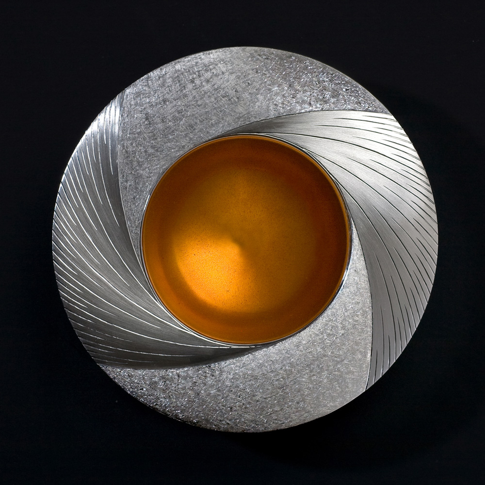 Midday Bowl Commission piece 2009. 110 mm diam. Silver, hand engraved, yellow / orange enamel. Photo : Simon Armitt