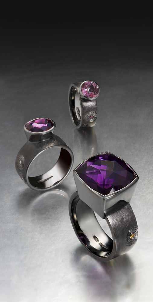 Silver finished in black rhodium, hand engraved in 'Zen' garden pattern. Amethyst, purple and mauve spinels, ring shanks set with treated and natural coloured diamonds. Photo: Simon B Armitt