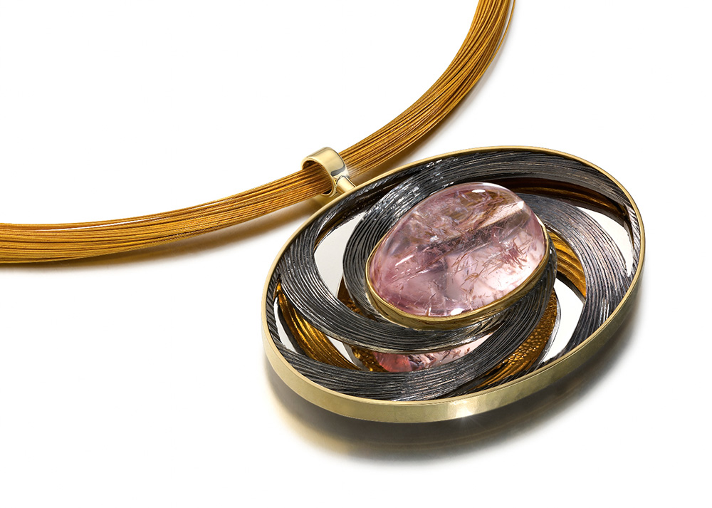 Silver, hand carved and engraved, part gilded, part black rhodium plated. Pink oval cabouchon tourmaline,Chain 22ct gold plated, stainless steel wires. 6 cm x 4 cm. 2013.Photo: Simon B Armitt