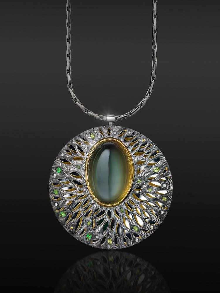 Silver, hand engraved and pierced with moonstone set in green gold, with green tourmalines and grey diamonds. (Commission)